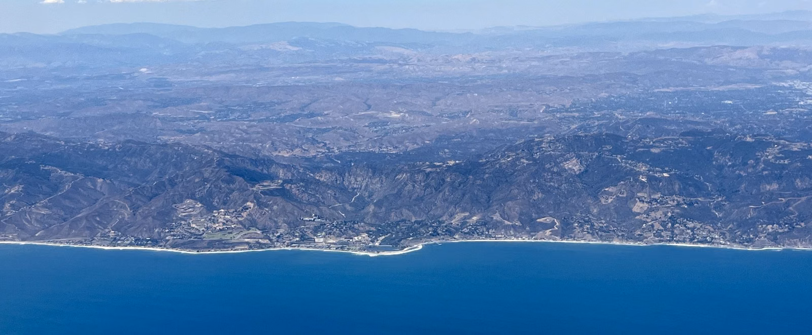 The Malibu coastline and the Santa Monica Mountains seen from an airplane over the ocean