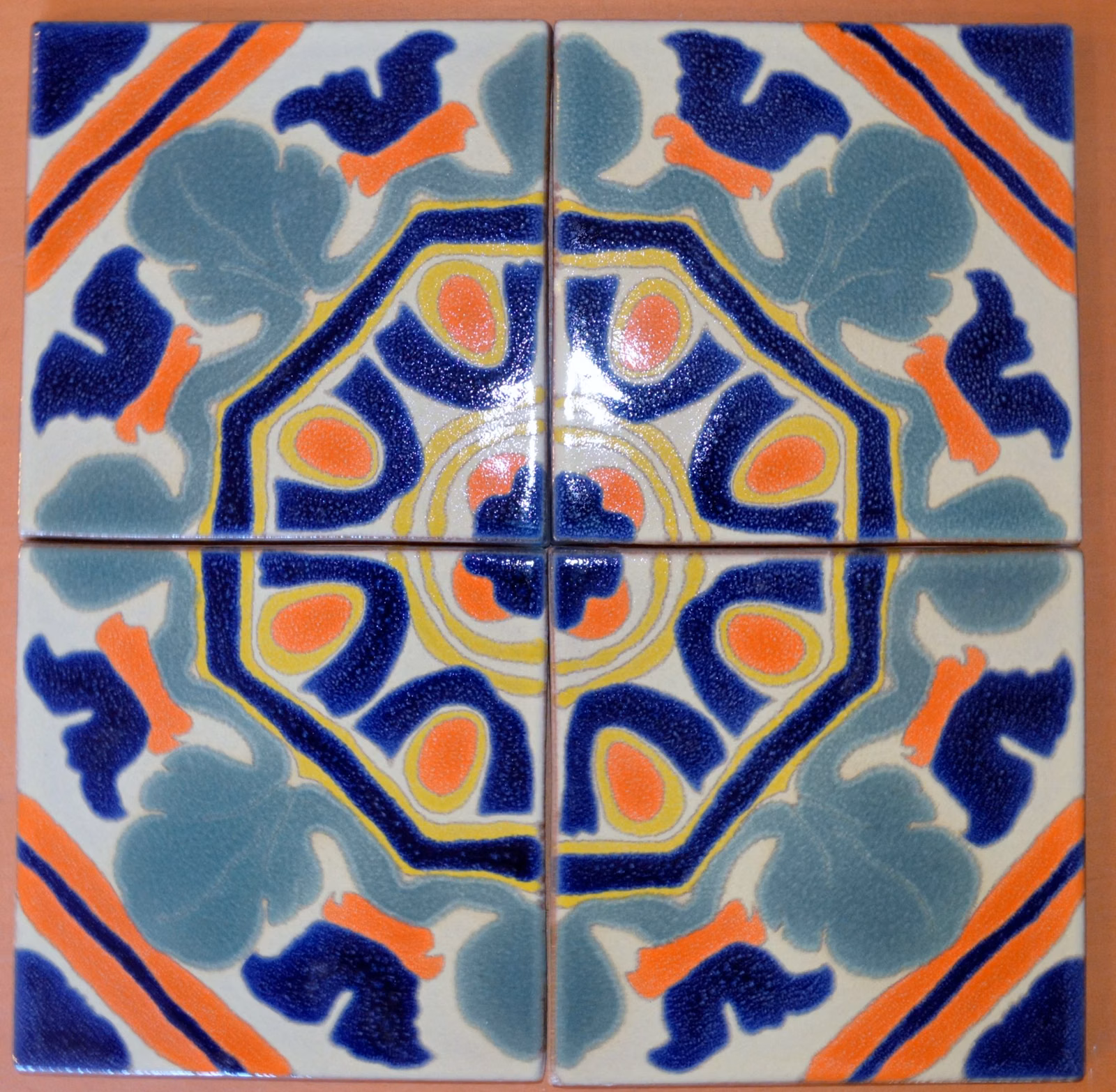 A four-tile pattern of reproduction Malibu Potteries tile in blue, yellow and green