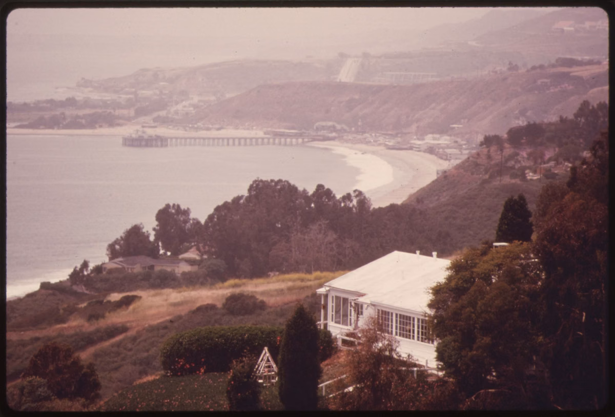 A 1975 view from the hills down to the Malibu Pier and the curve of the beach, from the EPA's Documerica project